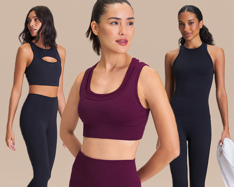 Three women wearing fitted activewear tops and leggings pose against a neutral beige background. The center model wears a burgundy sports bra, while the two models on either side wear black athletic tops and black leggings.