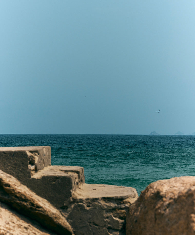 Minimal ocean view with rocky textures, evoking coastal calm and natural beauty.